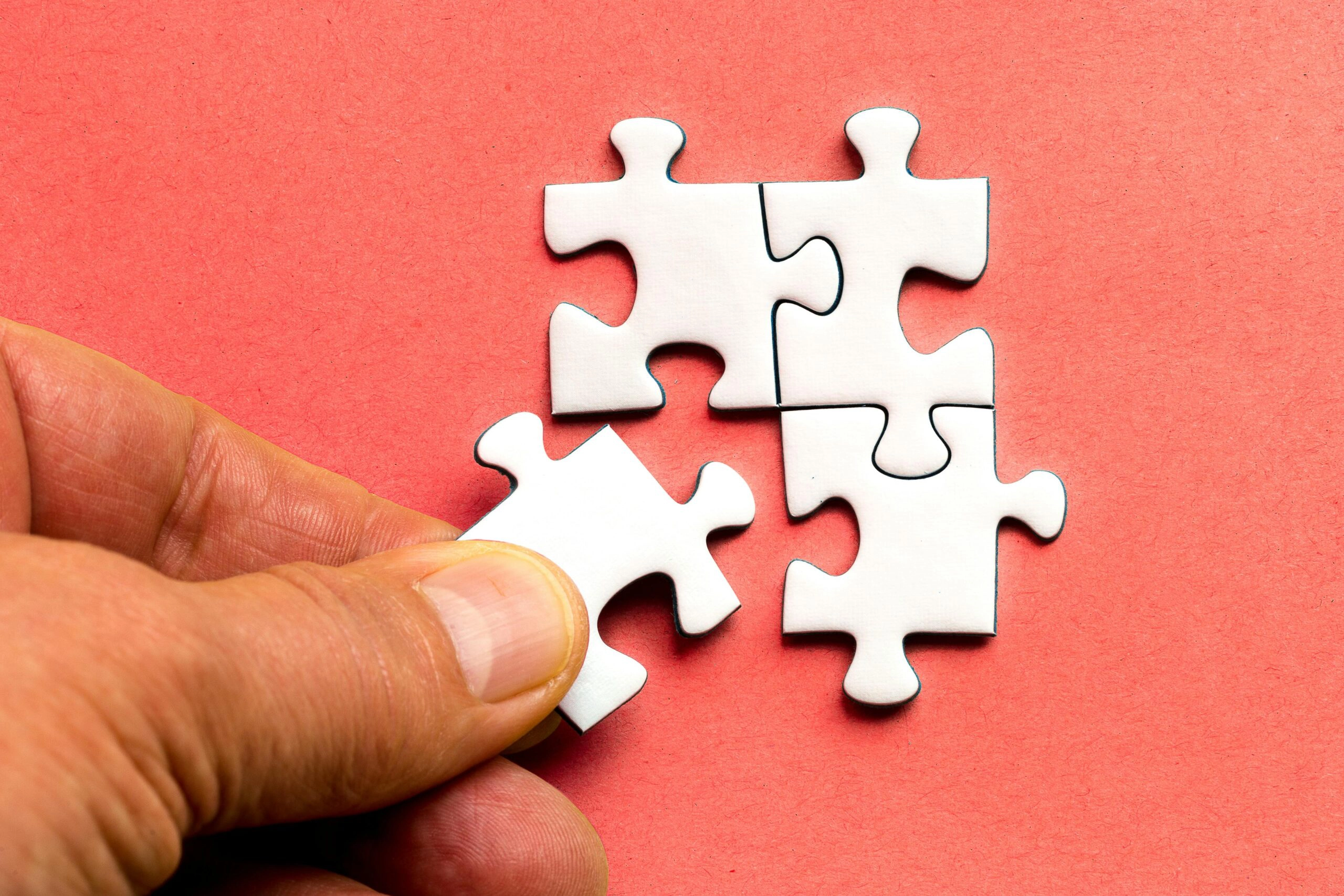 A hand placing a piece of the puzzle
